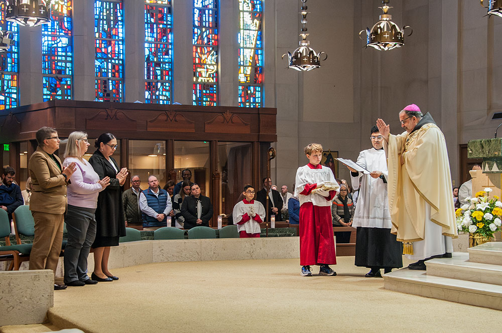 Bishop John Stowe of Lexington, Kentucky, blesses three women acolytes during Mass Nov. 24 at the Cathedral of Christ the King in Lexington. (Courtesy of Maureen C Guarnieri Yeager)