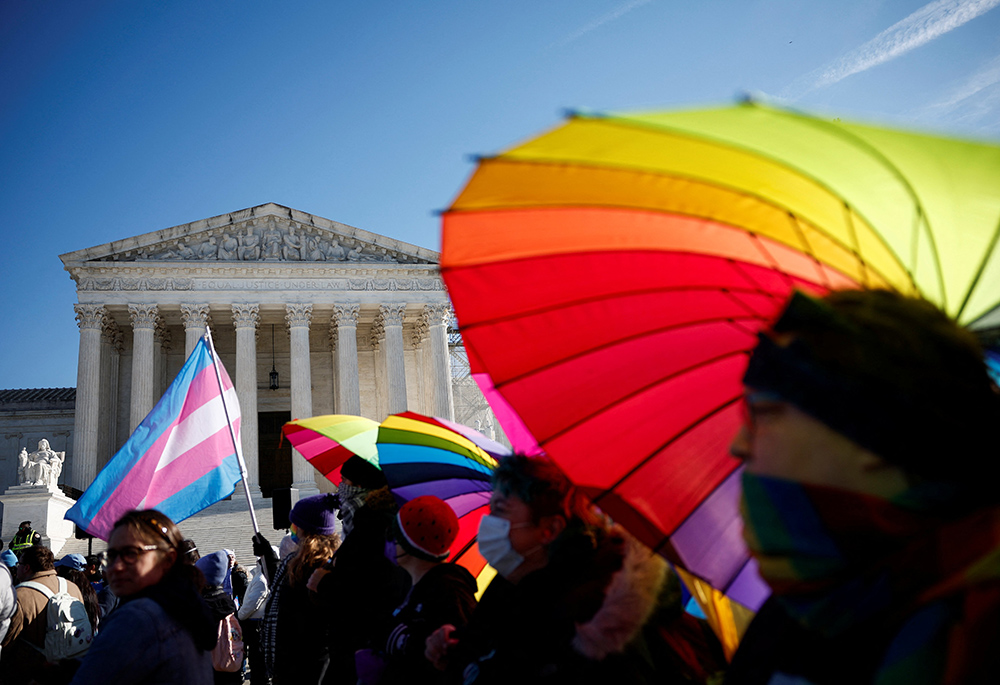 People hold rainbow-colored umbrellas and flags at a demonstration at the U.S. Supreme Court on Dec. 4, 2024. President Donald Trump signed executive orders Jan. 20 that direct the U.S. government to only recognize two sexes, male and female, and another ending diversity, equity and inclusion programs within federal agencies. (OSV News/Reuters/Benoit Tessier)