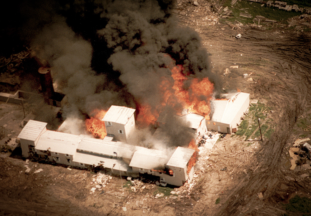 Aerial view of Branch Davidian compound near Waco, Texas, in flames on April 19, 1993, following a 51-day siege by the FBI and law enforcement. (Wikimedia Commons/FBI)