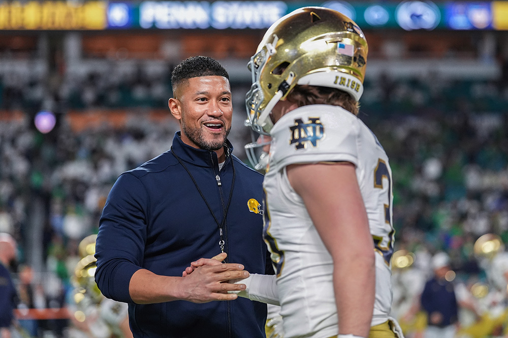 Notre Dame head coach Marcus Freeman greets a player before the Orange Bowl NCAA College Football Playoff semifinal game against Penn State, Thursday, Jan. 9, 2025, in Miami Gardens, Fla. (AP/Rebecca Blackwell)