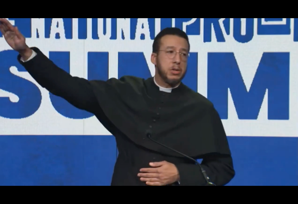 This is a screenshot from video of Anglican Fr. Calvin Robinson, who closed his remarks Jan. 25 at the National Pro-Life Summit in Washington, D.C., with a movement that appeared to be a Nazi gesture. Robinson later posted video of the gesture on X. (NCR screenshot/X)