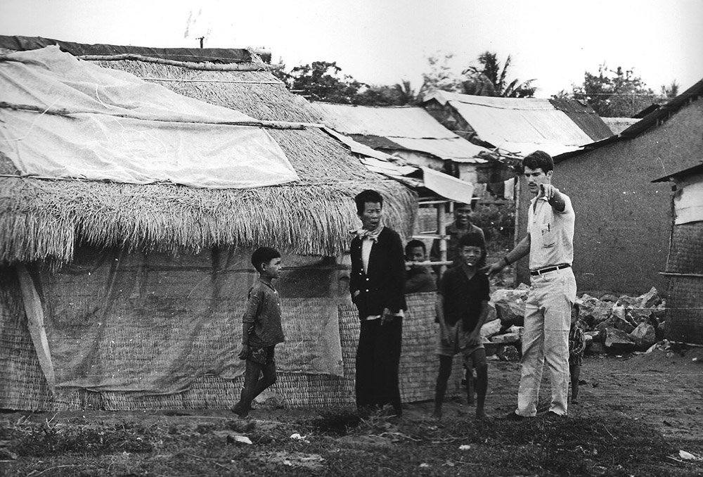 Tom Fox is photographed in 1967 with villagers at the Ninh Tinh refugee camp outside Tuy Hoa, Vietnam. (Courtesy of Thomas C. Fox)