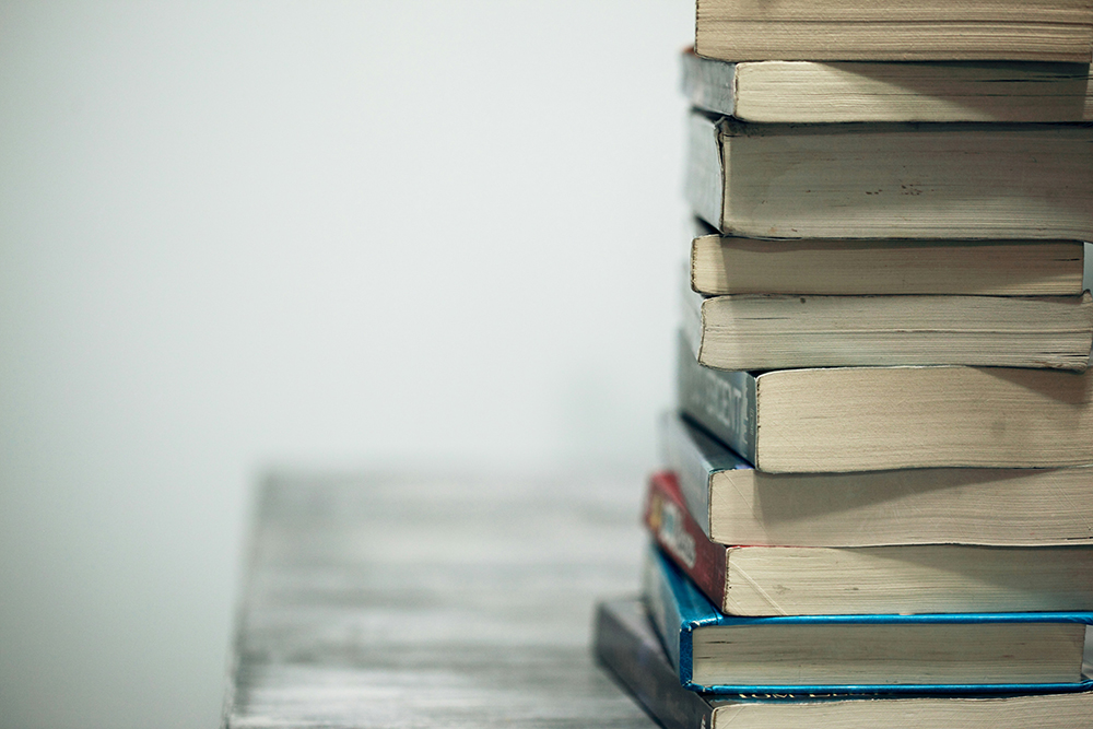 A stack of books (Unsplash/Alexander Grey)