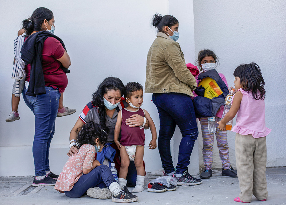 Migrants seeking asylum in the U.S. stand outside the office of the Center for Integral Attention to Migrants in Ciudad Juárez, Mexico, March 18, 2021. (CNS/Reuters/Jose Luis Gonzalez)