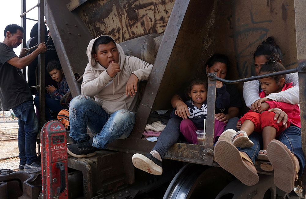 Central American migrants, moving in a caravan through Juchitan, Mexico, are pictured in a file photo on a train during their journey toward the United States. (OSV News photo/Reuters/Jose de Jesus Cortes)