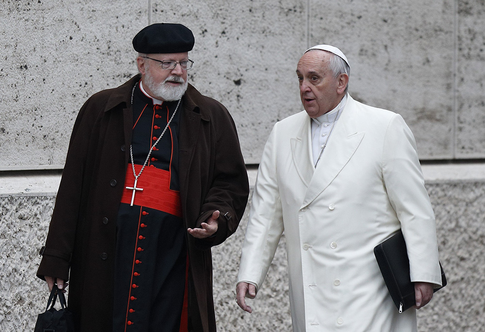 Pope Francis talks with Cardinal Sean O'Malley of Boston as they arrive for a meeting in the synod hall at the Vatican Feb. 13, 2015. O'Malley delivered a lecture, part of the Bergoglio Lecture Series, Feb. 26 at Sacred Heart University. (CNS/Paul Haring)