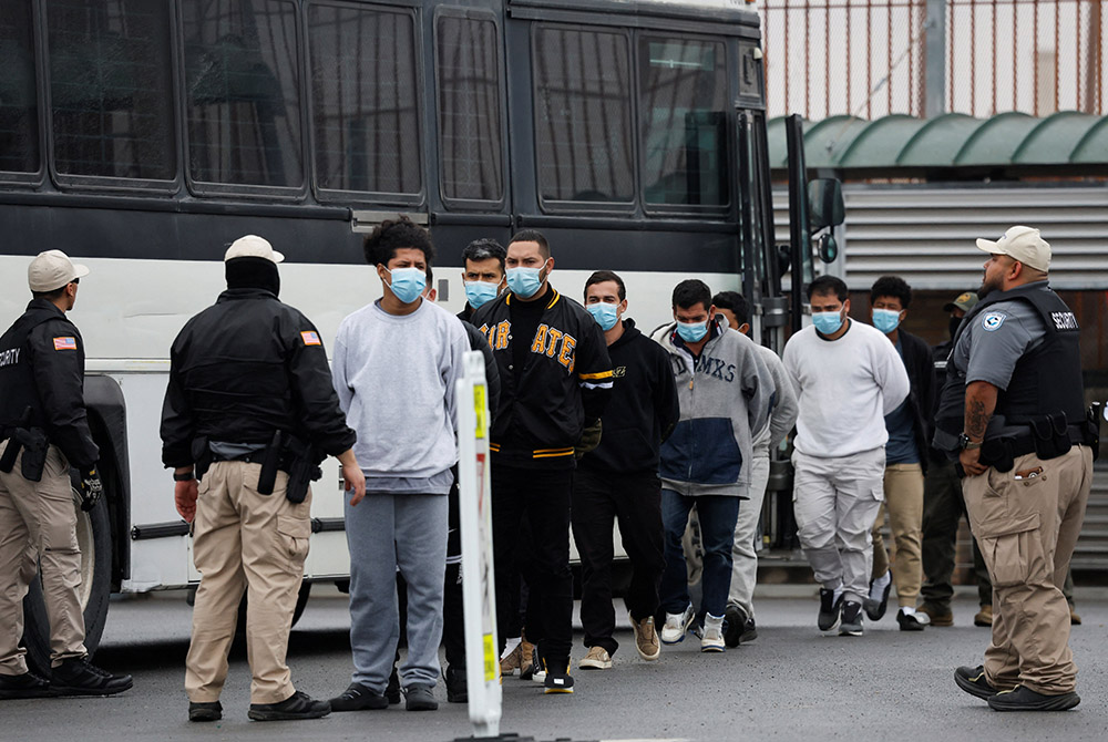 Migrants are escorted Jan. 27, 2025, across the Hidalgo International Bridge in McAllen, Texas, at the U.S.-Mexico border as they are deported under Title 8, a law that allows for immediate deportation after individuals cross into the U.S. without authorization. (OSV News/Reuters/Daniel Becerril)