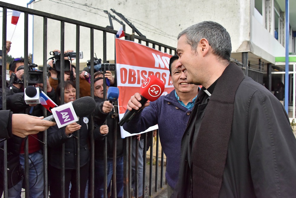 Msgr. Jordi Bertomeu Farnos smiles while talking to reporters.