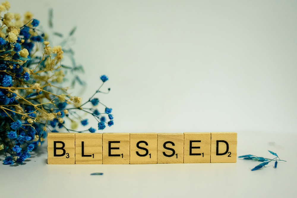 Block tiles spell out the word "Blessed" (Unsplash/Alex Shute)