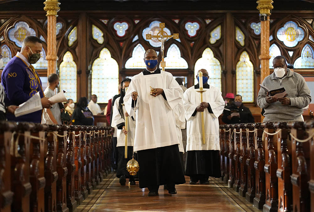 Toby Offiah, a seminarian of the Diocese of Brooklyn, leads the opening procession during a Mass marking Black Catholic History Month on Nov. 21, 2021. 