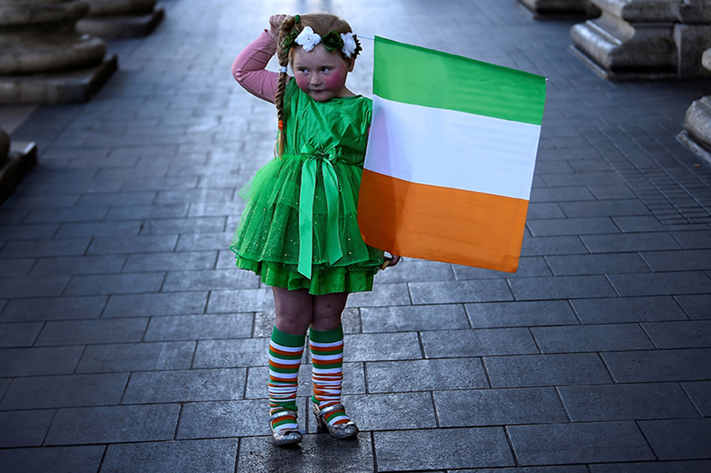 A girl who was part of a procession holds the flag of Ireland on St. Patrick's Day in Dublin March 17, 2021. (CNS/Reuters/Clodagh Kilcoyne)