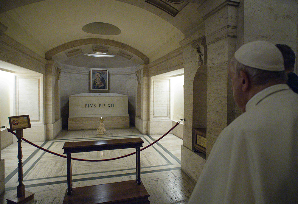 Pope Francis prays at the tomb of Pope Pius XII in the crypt of St. Peter's Basilica as he marks All Souls' Day at the Vatican on Nov. 2, 2021. (CNS/Vatican Media)