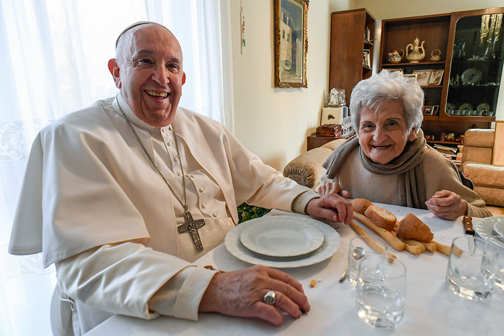 Pope Francis and his cousin Carla Rabezzana sit down for lunch in her home in Portacomaro, near Asti, Nov. 19, 2022. The pope traveled to the northern Italian town to help celebrate Rabezzana's 90th birthday, to visit other relatives and to celebrate Mass the next day in the Asti cathedral. (CNS/Vatican Media)