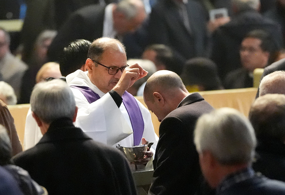 A priest distributes ashes during Ash Wednesday Mass at the Basilica of Santa Sabina, March 5 in Rome. (CNS/Lola Gomez)