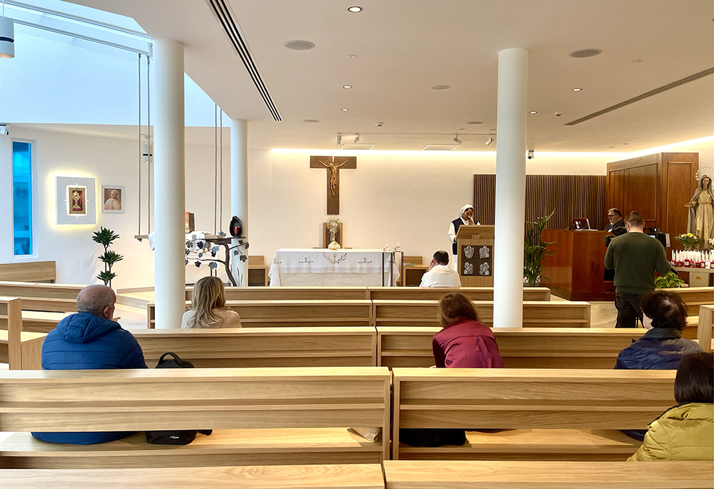 Faithful and Gemelli personnel pray in the St. John Paul II Chapel at Gemelli Hospital during a eucharistic adoration service led by Fr. Nunzio Currao, on March 7. (NCR photos/Camillo Barone)