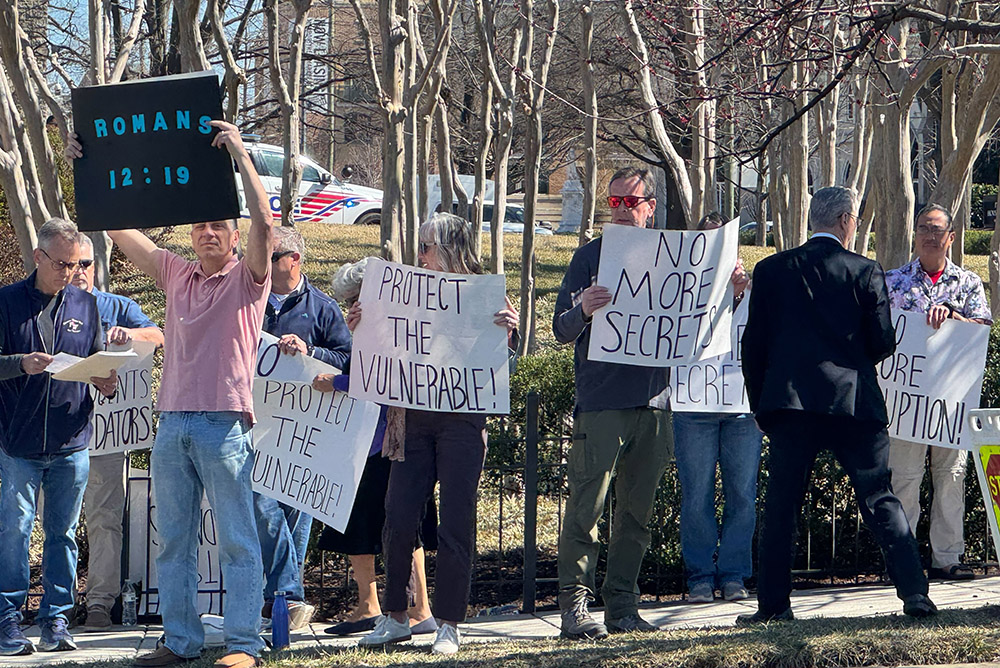 A group of protestors gather outside the  Basilica of the Shrine of the Immaculate Conception prior to Washington Cardinal Robert McElroy's installation Mass March 11. (NCR photo/Rhina Guidos)