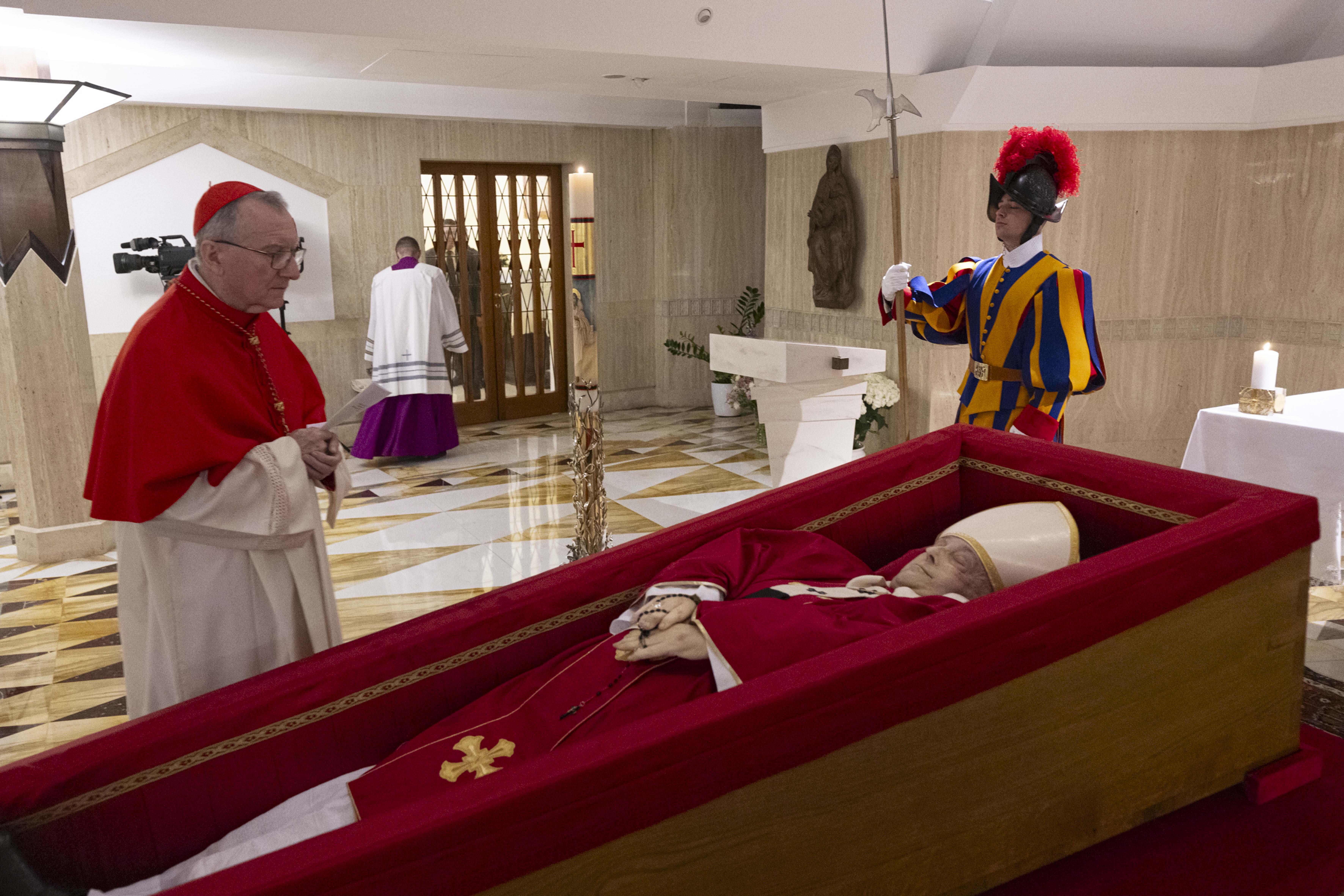 Cardinal Pietro Parolin, who served as Pope Francis' secretary of state, stands by the pope's coffin in the chapel of his residence, the Domus Sanctae Marthae, at the Vatican April 21, 2025. (CNS photo/Vatican Media)