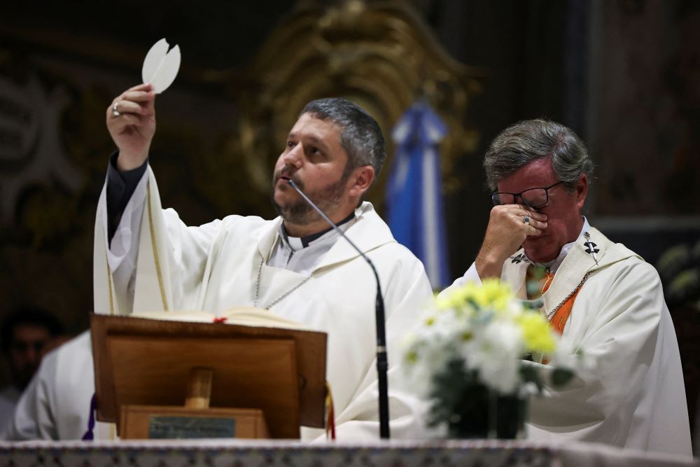 Archbishop Jorge Ignacio García Cuerva of Buenos Aires, right, reacts as he concelebrates Mass at the Basilica of San Jose de Flores April 21, 2025, following the death of Pope Francis. The pope, formerly Argentine Cardinal Jorge Mario Bergoglio, died April 21 at age 88. 