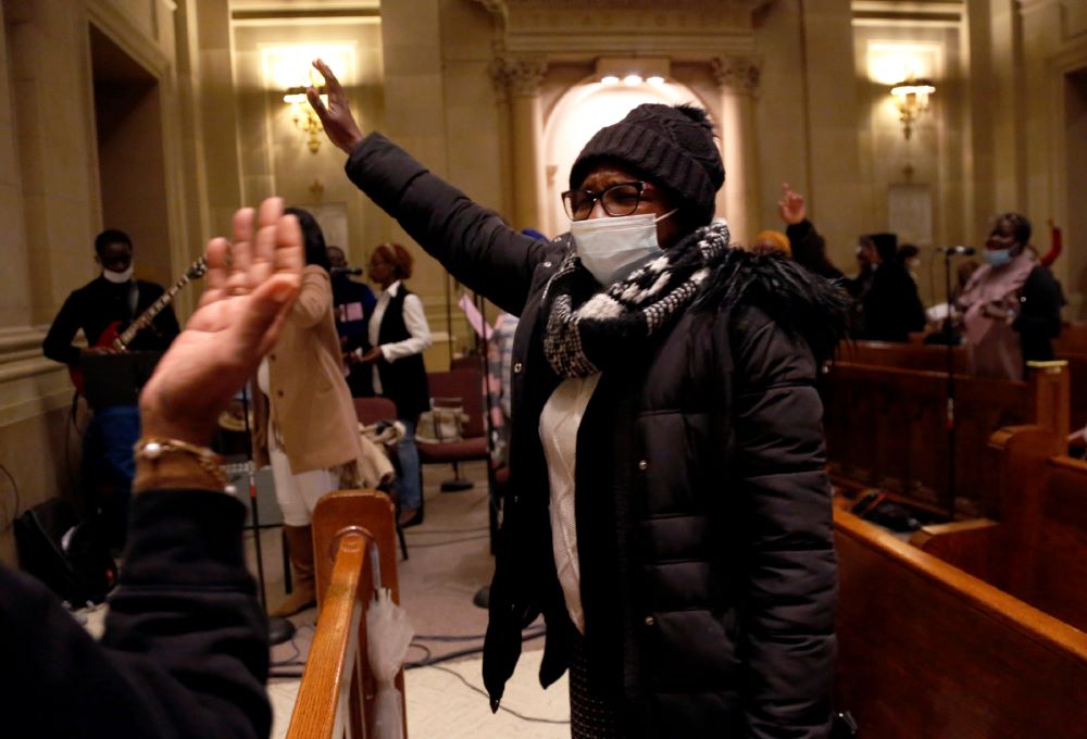 Aline Compaore sings along with the French choir, Chorale Sainte Marie Reine, at the end of Mass at the Church of Notre Dame in New York, on Sunday, March 6. Today, it is largely African Catholics who worship at the church's French service. (AP/Jessie War