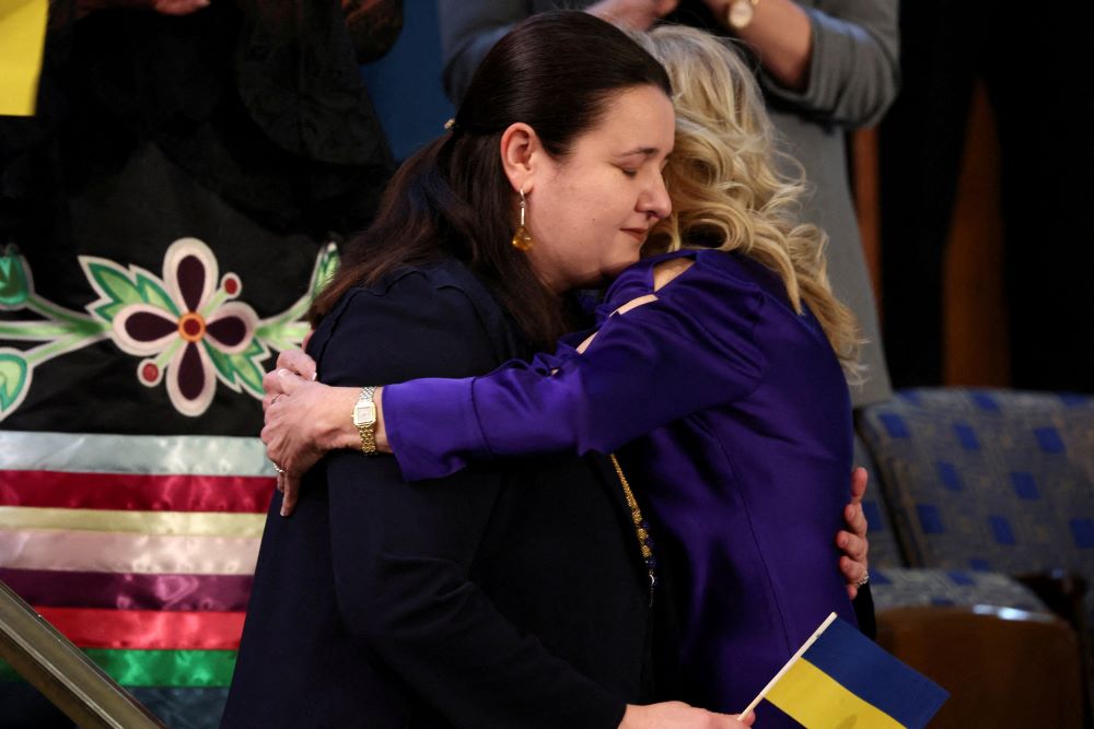 U.S. first lady Jill Biden embraces her guest, Ukrainian Ambassador to the U.S. Oksana Markarova. (CNS/Reuters/Evelyn Hockstein)