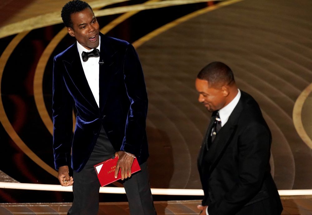 The comedian Chris Rock, left, reacts after actor Will Smith slaps him onstage during the 94th Academy Awards at the Dolby Theatre in Los Angeles March 27. (AP/Chris Pizzello)