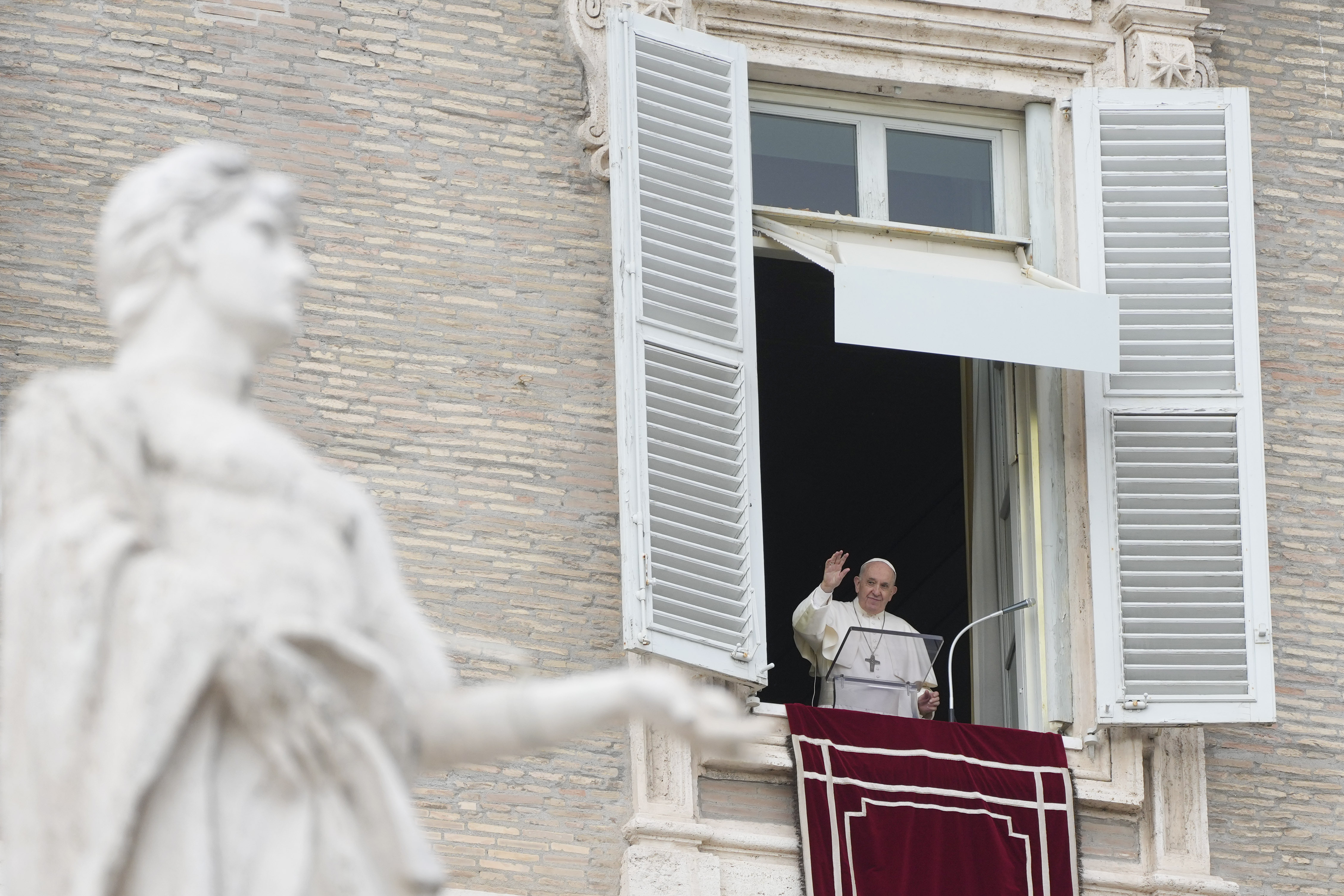 Pope Francis waves to faithful on the occasion of the Angelus noon prayer in St. Peter's Square, at the Vatican, Sunday, Nov. 14, 2021. (AP Photo/Gregorio Borgia)