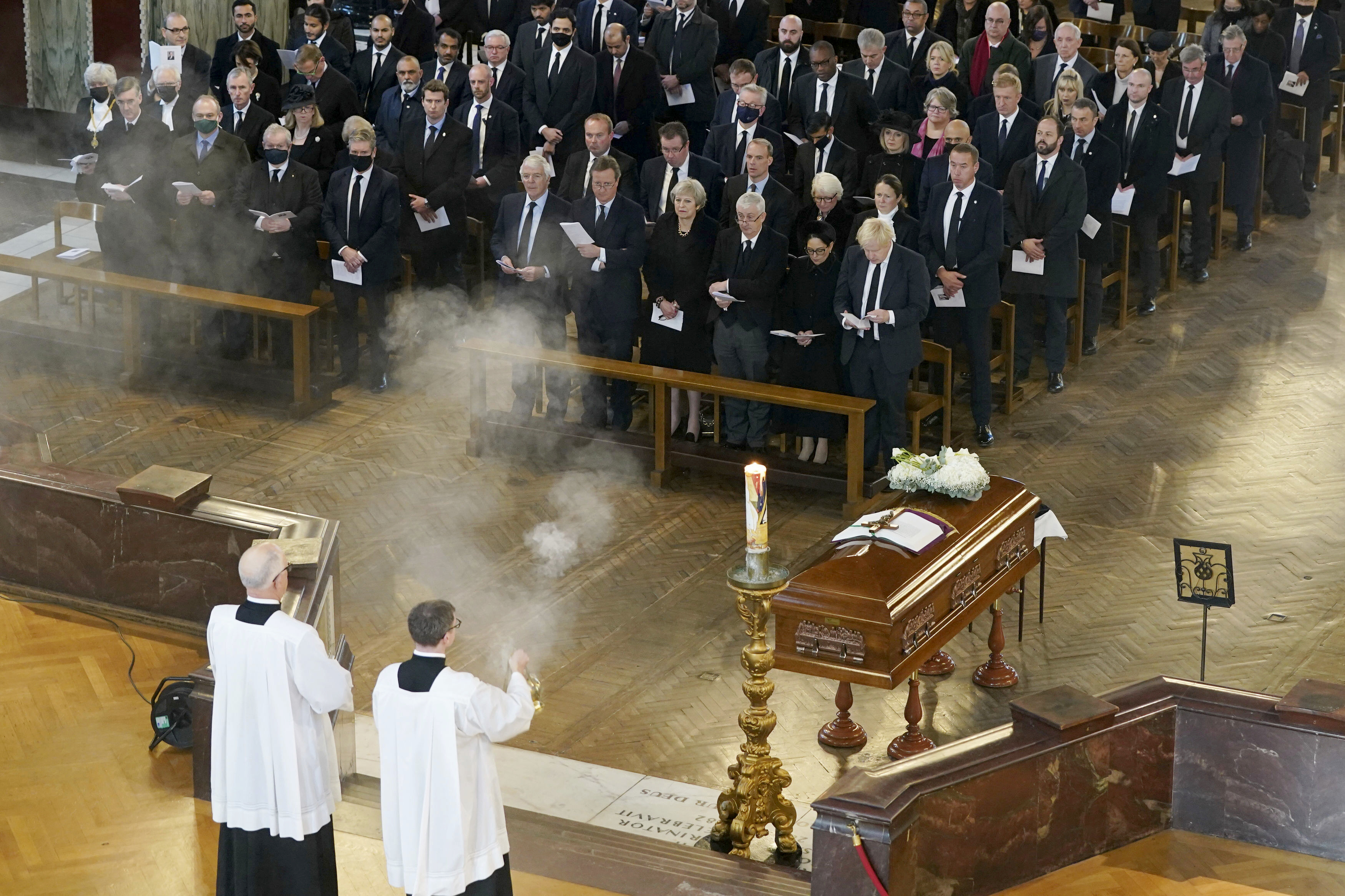 British Prime Minister Boris Johnson, right in front row, attends a Requiem Mass for slain member of parliament David Amess, inside Westminster Cathedral, central London, Tuesday, Nov. 23, 2021. (Stefan Rousseau/Pool Photo via AP)