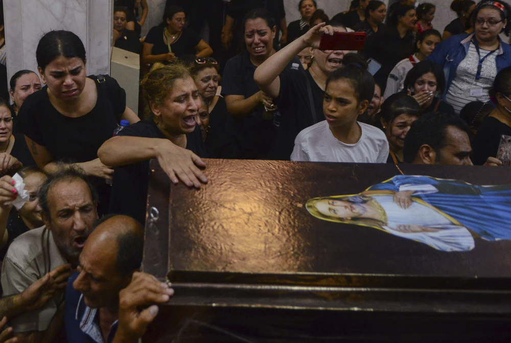 Mourners attend a memorial service for victims of a fire at a church in Greater Cairo that killed dozens on Aug. 14. (AP/Tarek Wajeh)