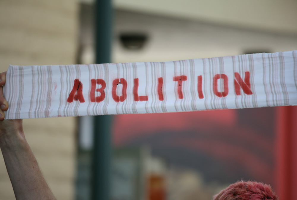 A call for abolition is seen in Santa Cruz, California, during a 2013 demonstration against prison overcrowding in the state. (Flickr/Richard Masoner)