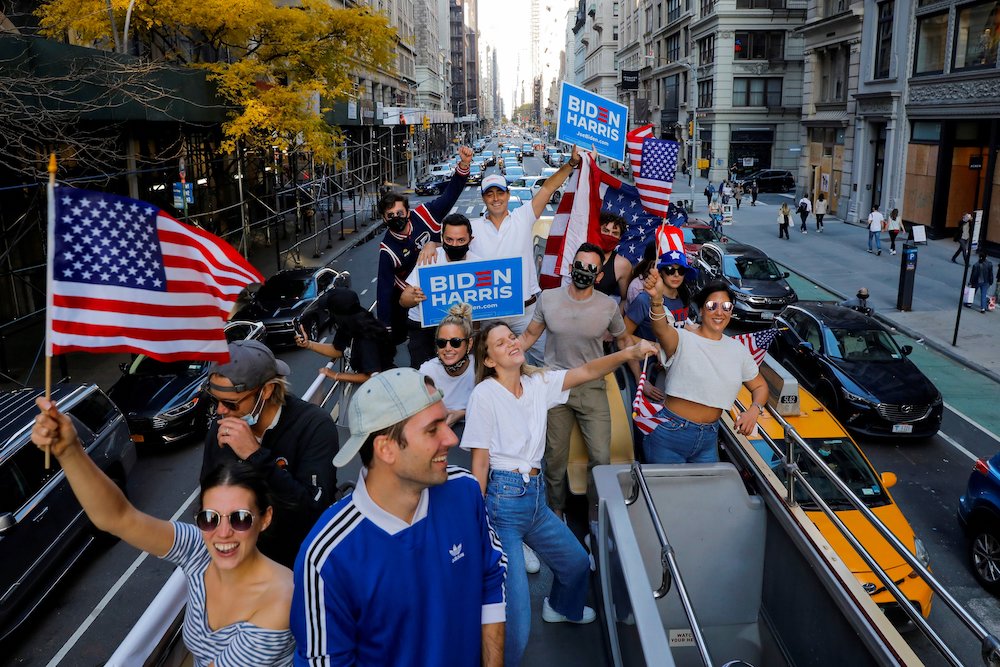 People ride down Fifth Avenue in New York City Nov. 8, a day after the news media declared Democrat Joe Biden declared the winner of presidential election. (CNS/Reuters/Andrew Kelly)