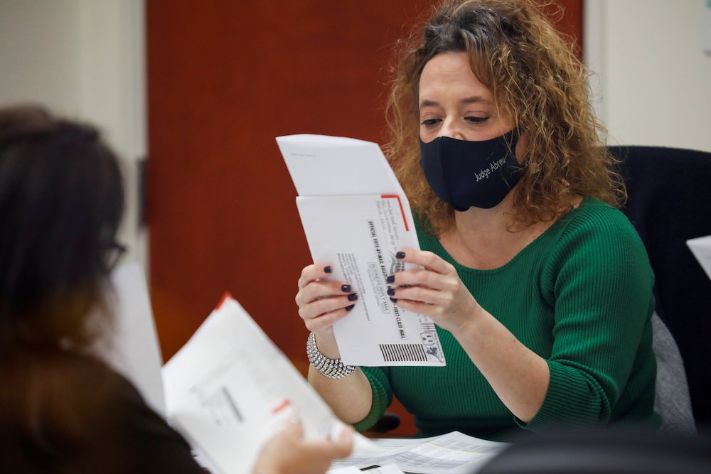 A poll worker reviews a ballot at the Miami-Dade County Elections Department during the presidential election in Miami Nov. 3. (CNS/Reuters/Marco Bello)