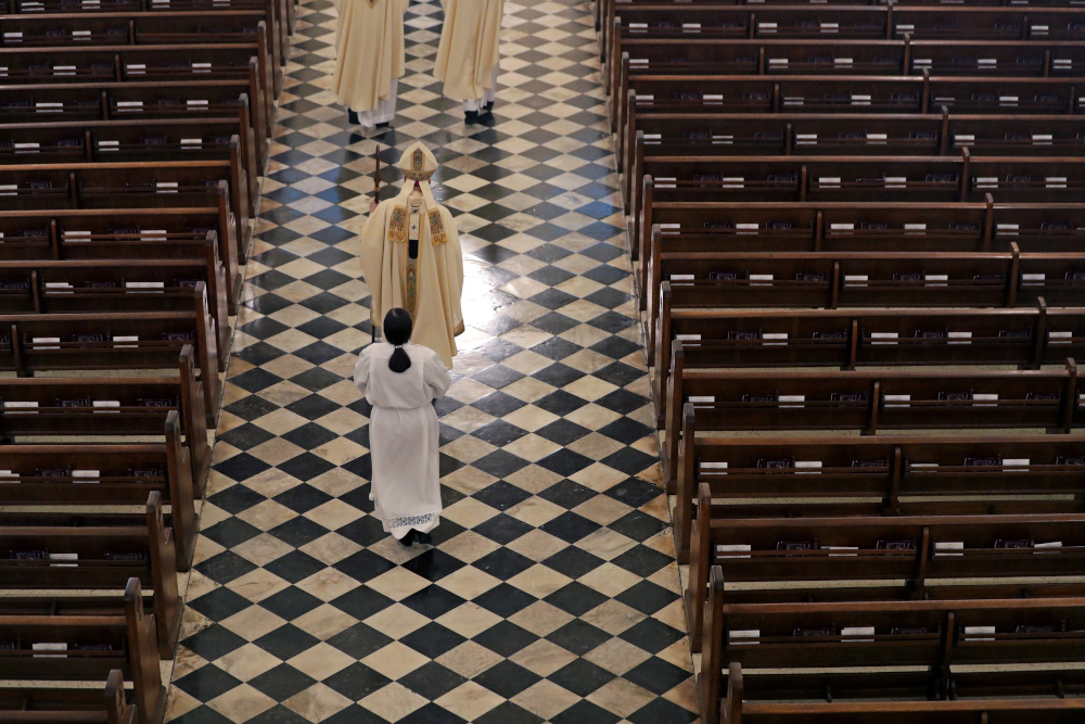 Archbishop Gregory Aymond conducts the procession to lead a live streamed Easter Mass in St. Louis Cathedral in New Orleans April 12, 2020. The New Orleans Archdiocese declined to discuss the federal investigation. (AP file photo/Gerald Herbert)