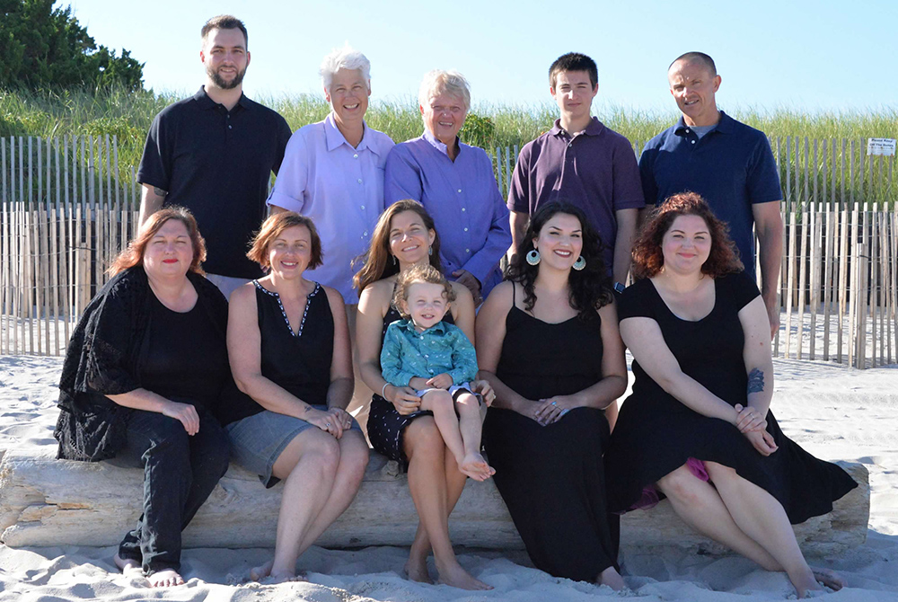 Honour Maddock and Kathleen Kane, standing second and third from the left, are pictured in a 2016 family photo with Kathleen's two daughters and son, their daughter-in-law and son-in-law, and their two granddaughters and two grandsons. (Courtesy photo)