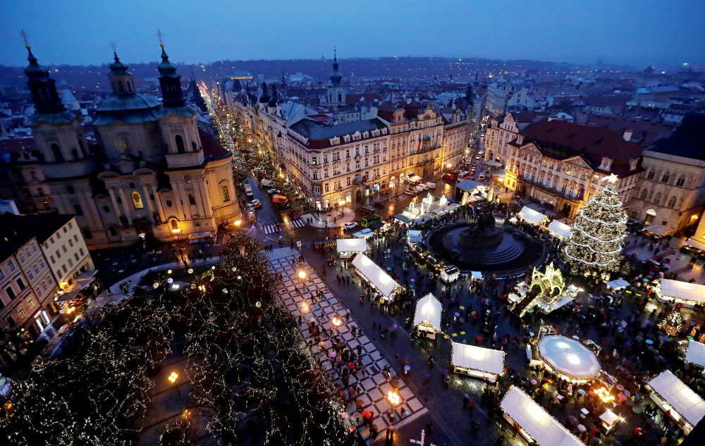 A Christmas tree is illuminated as people visit the traditional Christmas market Dec. 2 at the Old Town Square in Prague, Czech Republic. (CNS/Reuters/David W Cerny)