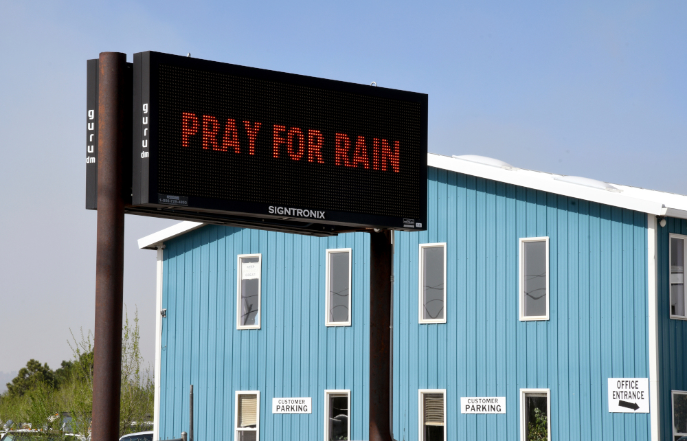 An electronic sign outside a business in Las Vegas, New Mexico, on Wednesday, May 4, 2022, asks passersby to "Pray for Rain" as a massive wildfire spreads in the nearby mountains. (AP/Thomas Peipert)