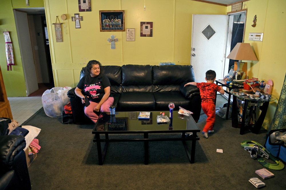 Crosses and religious quotes adorn the walls of Martina Gonzales' Las Vegas, New Mexico home on Tuesday, May, 3, 2022. (AP/Thomas Peipert)