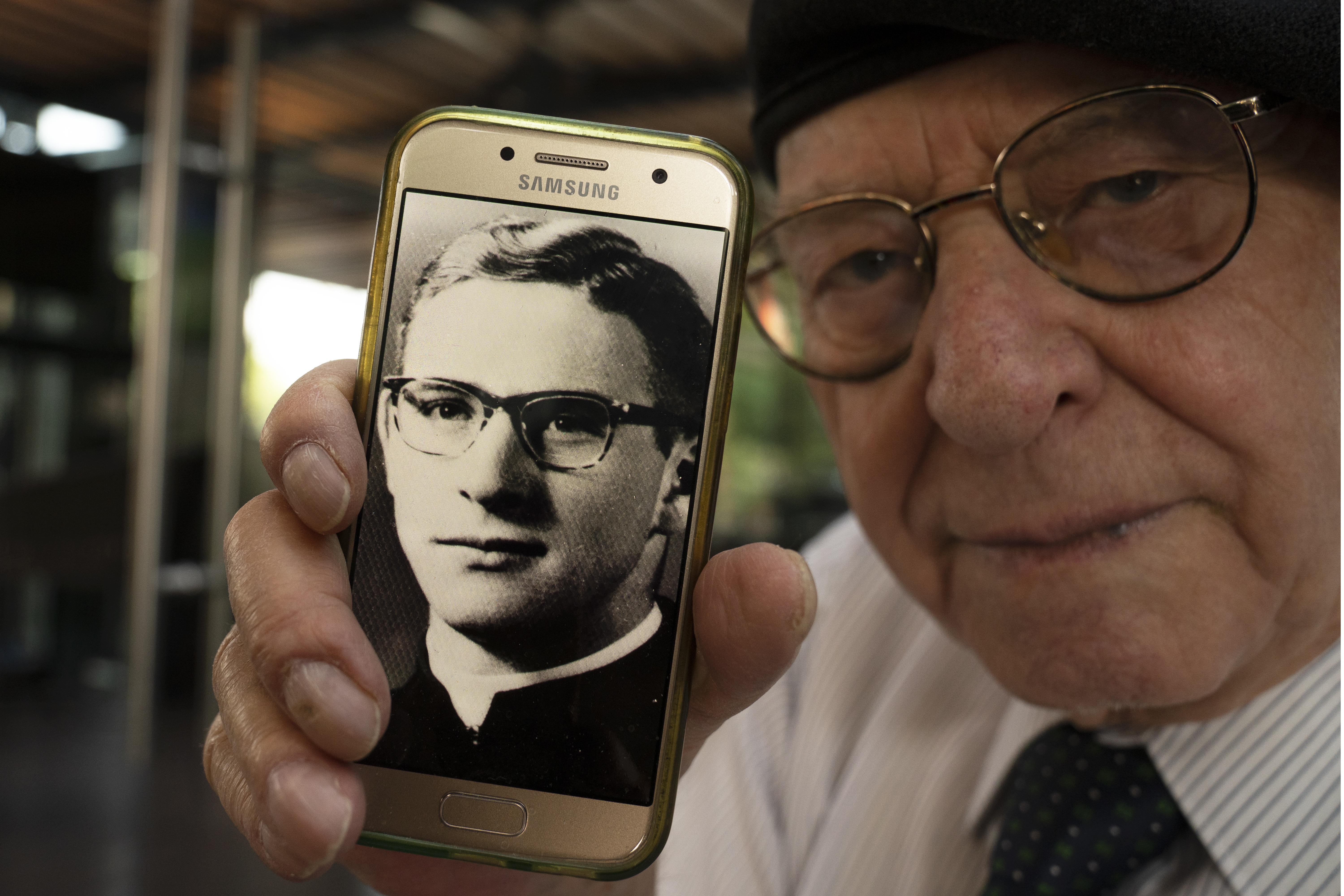 Jose Barba shows a photo of himself when he was a 18-year-old seminarian student, Mexico City, Feb. 22, 2022. (AP Photo/Marco Ugarte)