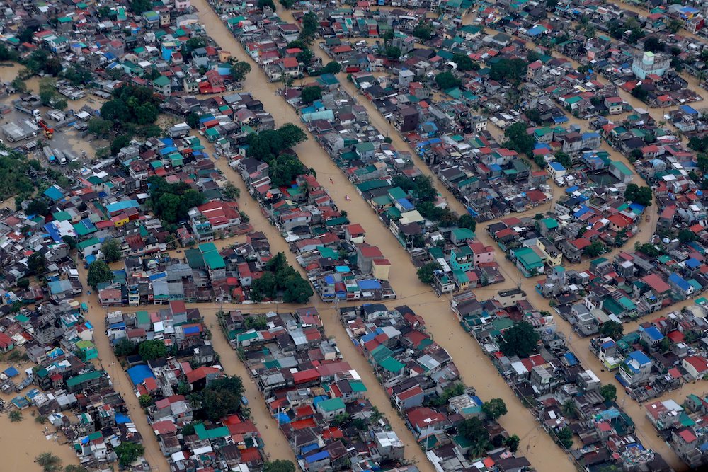 Floodwaters surround homes in Manila, Philippines, following Typhoon Vamco in 2020. Besides being battered by increasingly severe storms, the city is at serious risk from rising sea levels, bishops warn. (CNS photo/Presidential handout photo via Reuters) 