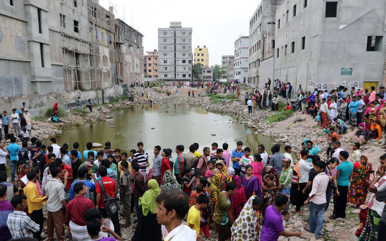 Relatives of victims gather at the Rana Plaza site on April 24, 2015, the second anniversary of the collapse of the garment factory in Savar, near Dhaka, Bangladesh. (Newscom/NurPhoto)