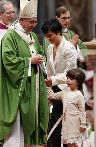 Family members leave after presenting offertory gifts to Pope Francis during a Mass to open last year's extraordinary Synod of Bishops on the family in St. Peter's Basilica at the Vatican Oct. 5, 2014. (CNS/Paul Haring)