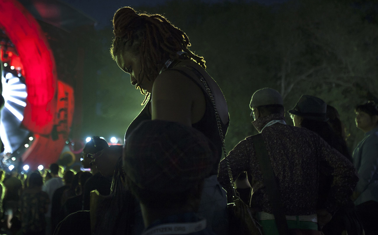 A woman looks at her cellphone during a Sept. 27, 2014, event in New York's Central Park. (CNS/Carlo Allegri, Reuters)