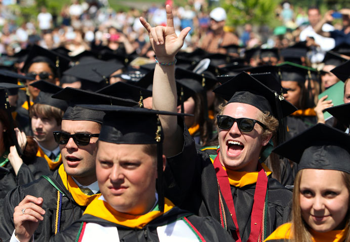 A graduating senior cheers during the 65th commencement at Jesuit-run Le Moyne College in Syracuse, N.Y., May 17, 2015. Cardinal Timothy M. Dolan of New York delivered the ceremony's commencement address and received an honorary degree. (CNS/Gregory A. Shemitz)