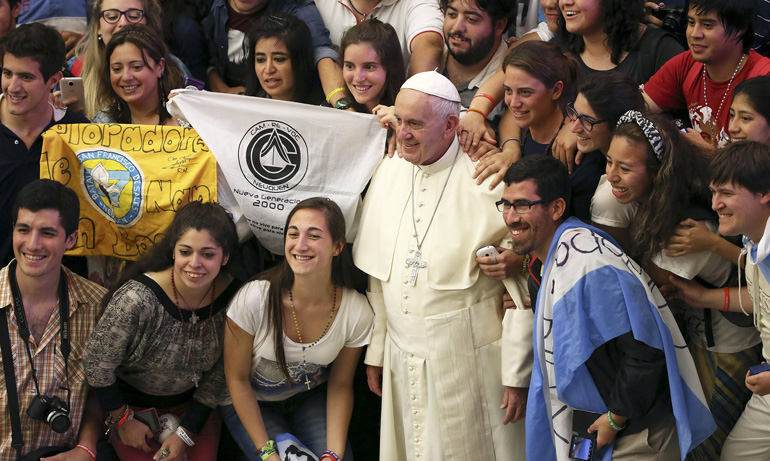 Pope Francis poses for a photo with Argentine youths during his weekly audience in Paul VI hall at the Vatican Aug. 19. (CNS/Alessandro Bianchi, Reuters)