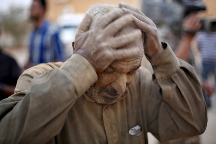 A Syrian refugee man covered with dust arrives at the Jordanian border with Syria, and Iraq, near the town of Ruwaished, near of Amman Sept. 10. (CNS/Muhammad Hamed, Reuters)