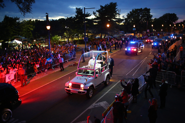 Pope Francis waves to crowds along Benjamin Franklin Parkway as he arrives for the Festival of Families for the World Meeting of Families in Philadelphia Sept. 26. (CNS photo/Eric Thayer, pool)