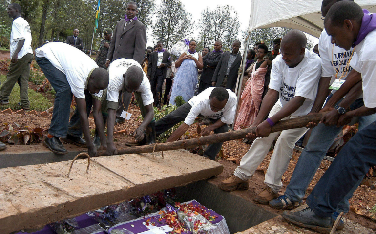 Volunteers are seen in 2005 burying the remains of victims of the 1994 genocide in Murambi, Rwanda. (CNS/EPA/Ricky Gare)