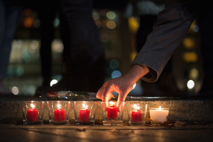 People light candles in tribute to the victims of the Paris attacks, outside the French Embassy in Berlin, Germany, Nov. 13. Dozens of people were killed in a series of attacks in Paris Nov. 13. (CNS photo/Lukas Schulze, EPA) 