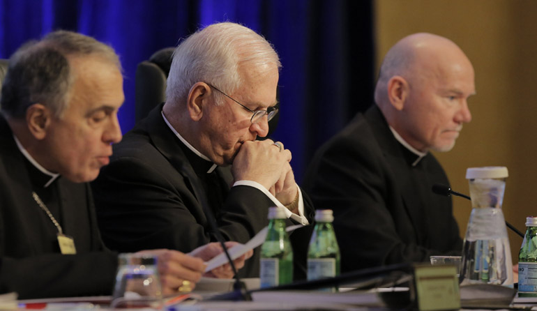 Cardinal Daniel N. DiNardo leads the opening prayer Nov. 16 alongside Archbishop Joseph E. Kurtz and Msgr. Ronny Jenkins, during the 2015 USCCB fall general assembly in Baltimore. (CNS/Bob Roller)