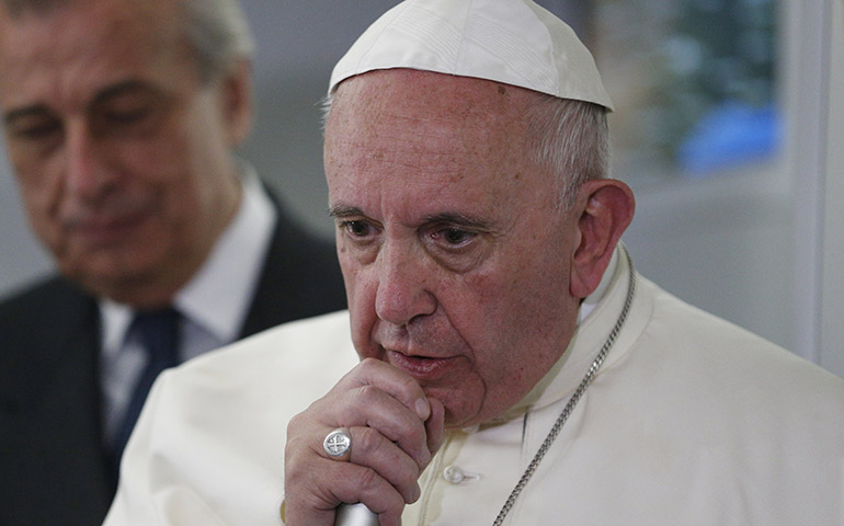 Pope Francis answers questions from journalists aboard his flight from Ciudad Juarez, Mexico, to Rome Feb. 17. (CNS/Paul Haring)