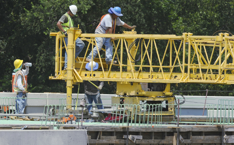 Highway construction workers are seen in Dallas in this 2011 file photo. (CNS/EPA/Larry W. Smith)